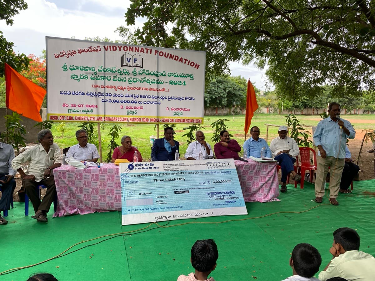 Vidyonnati Foundation 2024 scholarship ceremony with banner and cheque