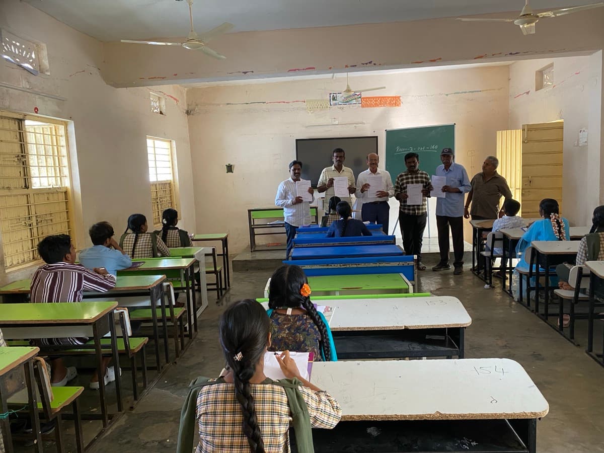 Students appearing for screening test in classroom